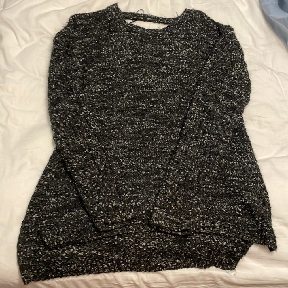 Cute black sweater with cross back.